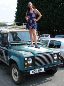 Hippy chick standing on bonnet